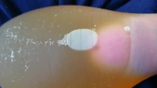 Pissing into a condom freshly filled with warm piss